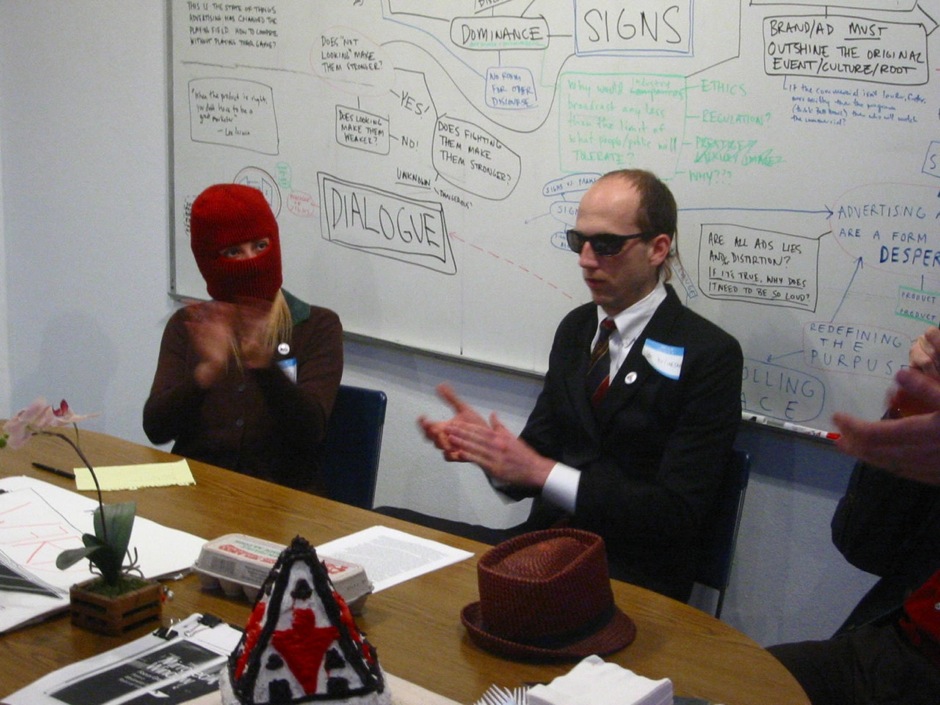Mabel Negrete (hooded) and Josh Short the Anonymous Business Man